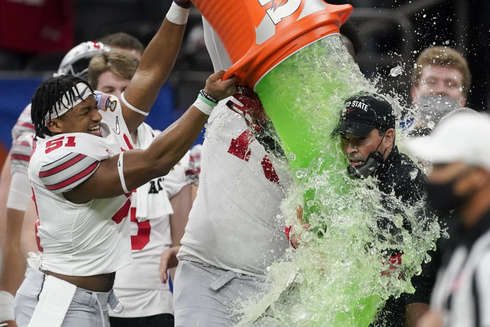 Ohio State head coach Ryan Day get soaked with a sports drink after the team's win against Clemson during the Sugar Bowl NCAA college football game Friday, Jan. 1, 2021, in New Orleans. (AP Photo/John Bazemore)