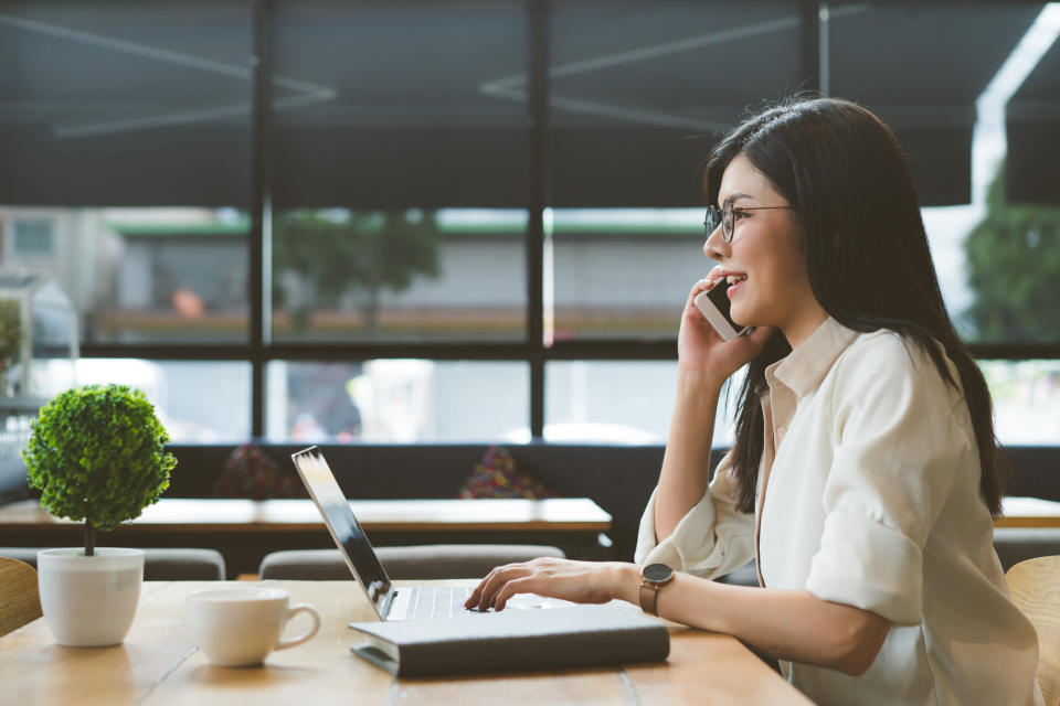 Businesswoman Using Laptop At Desk In Office. Source: Getty 