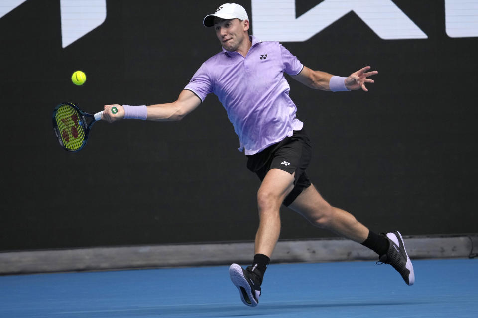 Casper Ruud of Norway plays a forehand return to Jenson Brooksby of the U.S. during their second round match at the Australian Open tennis championship in Melbourne, Australia, Thursday, Jan. 19, 2023. (AP Photo/Dita Alangkara)