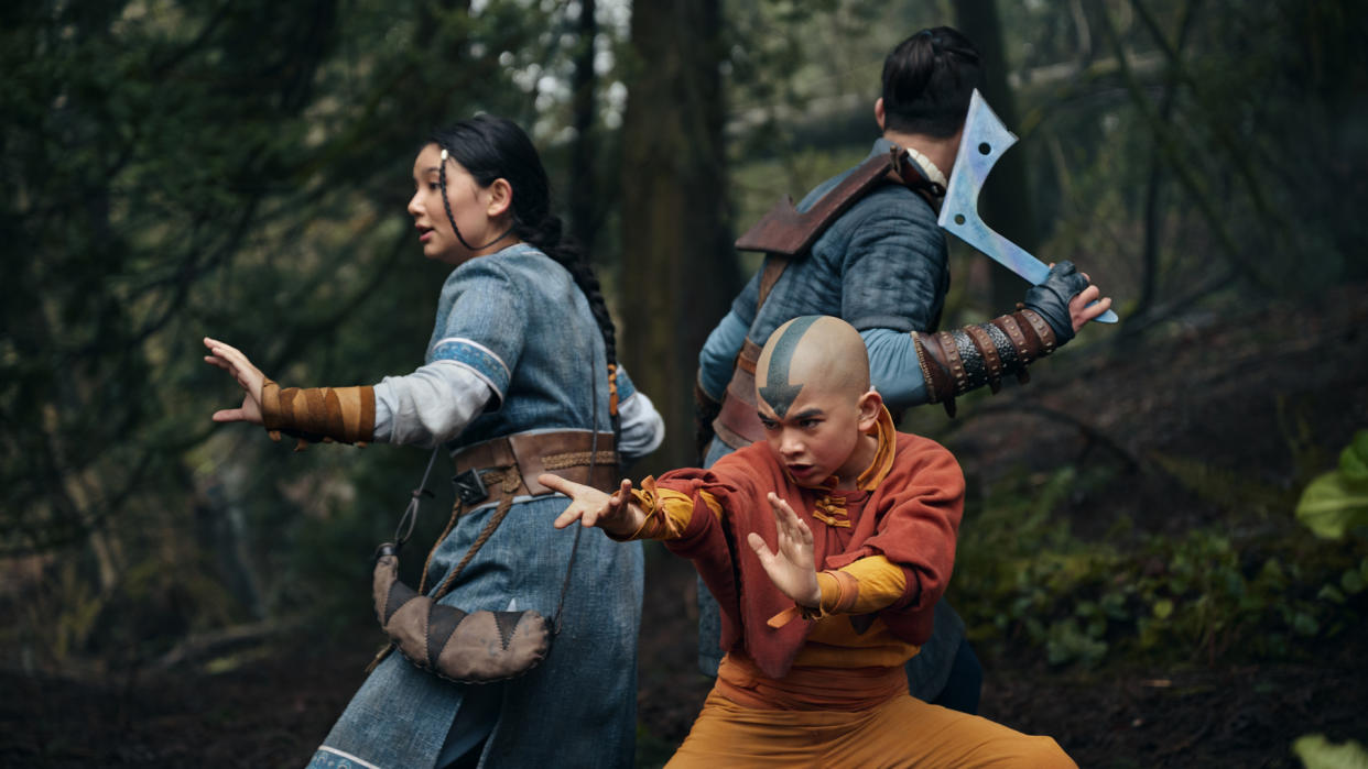  Katara, Aang, and Sokka stand back to back as they prepare to fight in Netflix's Avatar: The Last Airbender. 