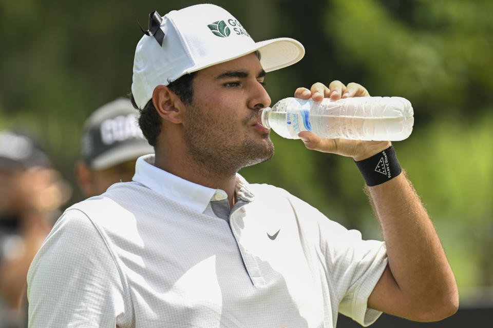 Eugenio Lopez-Chacarra from Spain takes a drink of water on the 11th hole during LIV Golf Invitational Bangkok 2022 at Stonehill Golf Club in Pathum Thani, Thailand, Saturday, Oct. 8, 2022. (AP Photo/Kittinun Rodsupan)