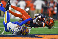 Syracuse wide receiver Courtney Jackson, right, crosses the goal line over Pittsburgh defensive back Judson Tallandier II for a touchdown during the first half of an NCAA college football game in Syracuse, N.Y., Saturday, Nov. 27, 2021. (AP Photo/Adrian Kraus)