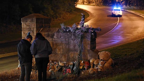 PHOTO: People gather at a makeshift memorial for victims outside the Covenant School building at the Covenant Presbyterian Church following a shooting, in Nashville, Tennessee, March 27, 2023. (Brendan Smialowski/AFP via Getty Images)