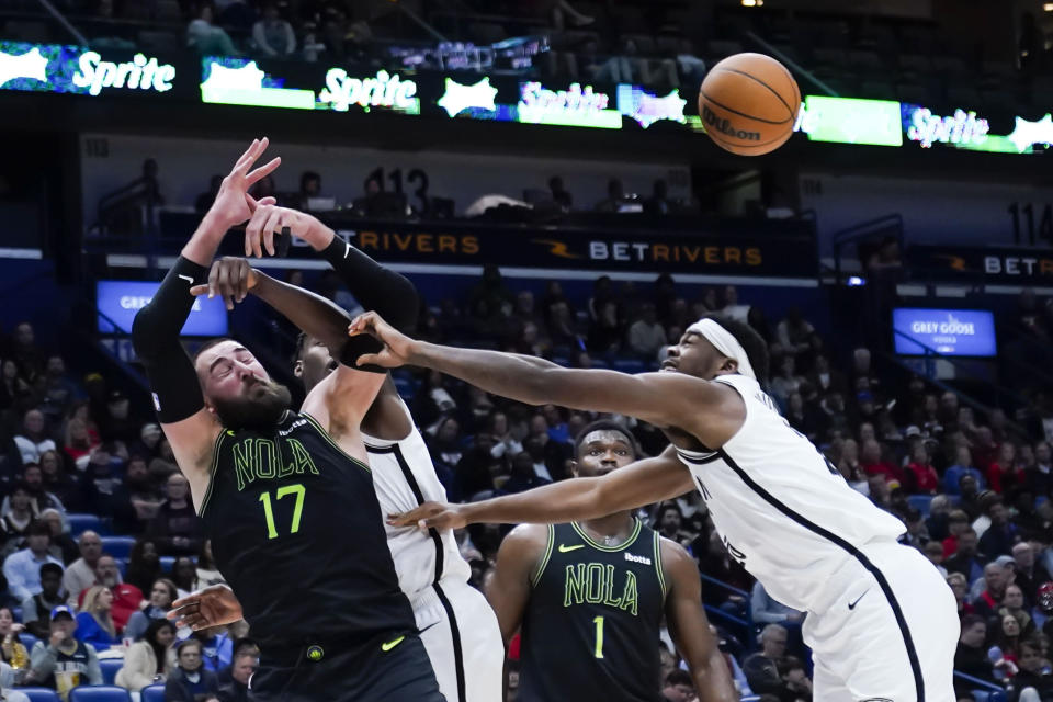 New Orleans Pelicans center Jonas Valanciunas (17) battles under the basket with Brooklyn Nets center Day'Ron Sharpe in the second half of an NBA basketball game in New Orleans, Tuesday, Jan. 2, 2024. The Pelicans won 112-85. (AP Photo/Gerald Herbert)