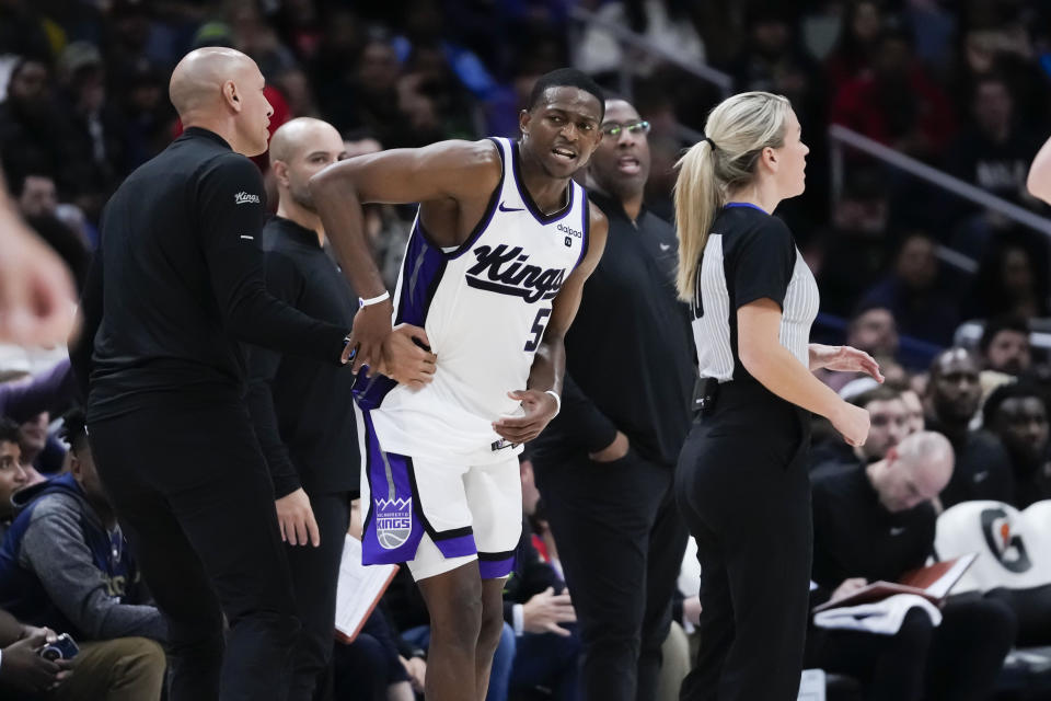 Sacramento Kings guard De'Aaron Fox (5) is restrained by coaching staff as he argues with officials in the second half of an NBA basketball game against the New Orleans Pelicans in New Orleans, Wednesday, Nov. 22, 2023. The Pelicans won 117-112. (AP Photo/Gerald Herbert)