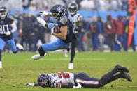 Tennessee Titans wide receiver Nick Westbrook-Ikhine (15) is brought down by Houston Texans cornerback Desmond King (25) in the second half of an NFL football game Sunday, Nov. 21, 2021, in Nashville, Tenn. (AP Photo/Mark Zaleski)