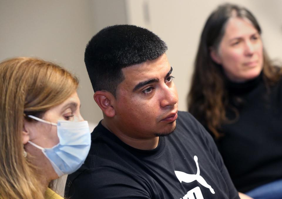 Interpreter Angela Hoke, left, and attorney Nina Froes are present for José Daniel Guerra-Castañeda during an interview at ACLU-NH's office in Concord, New Hampshire, on May 11, 2022.