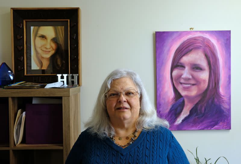 Susan Bro poses with a photo and portrait of her daughter, Heather Heyer, on Dec. 13, 2017. (Photo: Norm Shafer for The Washington Post via Getty Images)