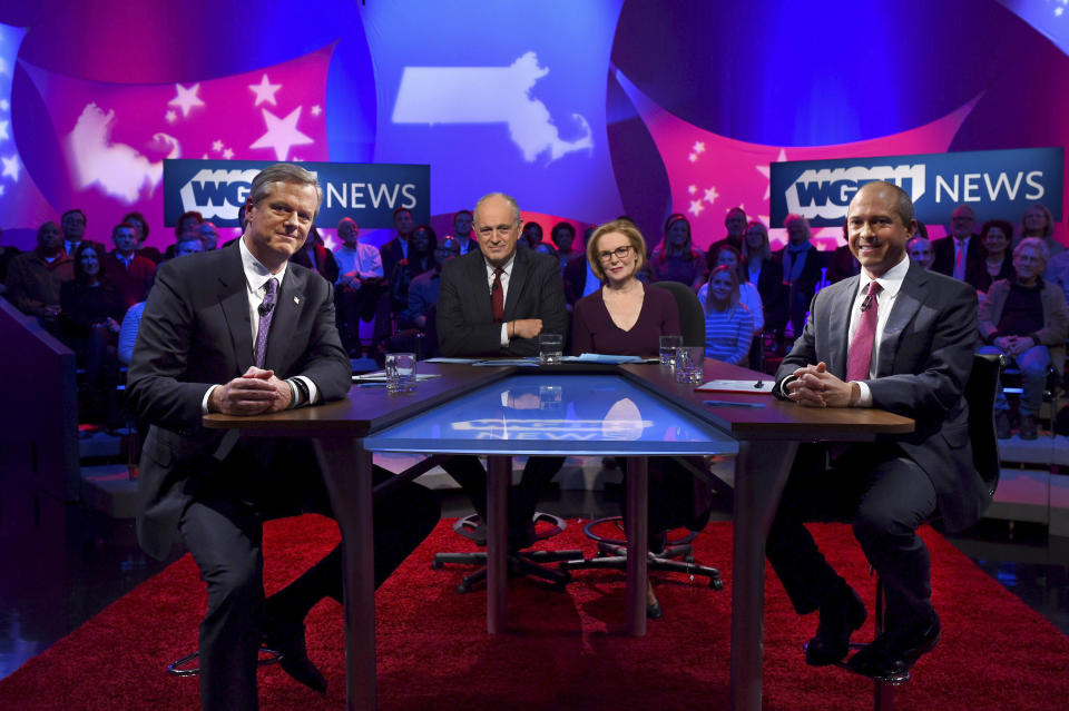 CORRECTS NAME OF STATION TO WGBH-TV IN FIRST REFERENCE FROM WBGH-TV - from Republican Massachusetts Gov. Charlie Baker, left, and Democratic challenger Jay Gonzalez, right, pose with hosts Jim Braude and Margery Eagan prior to a gubernatorial debate at the studios of WGBH-TV in Boston, Wednesday Oct. 17, 2018. (Meredith Nierman/WGBH-TV via AP, Pool)