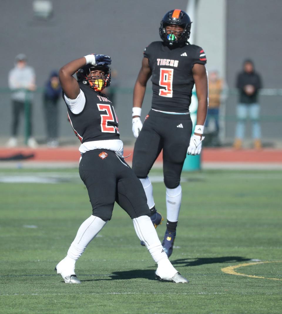 Belleville defender Kristopher Easley celebrates his sack on Davison quarterback Sawyer Glennie during first-half action at Novi High School on Saturday, Nov. 18, 2023.