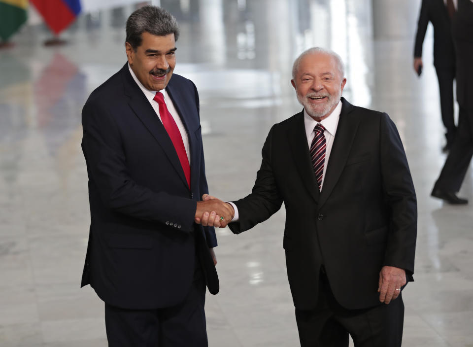 Brazilian President Luiz Inacio Lula da Silva, right, shakes hands with Venezuela's President Nicolas Maduro prior to their bilateral meeting at Planalto palace in Brasilia, Brazil, Monday, May 29, 2023. Maduro is in Brazil for the Union of South American Nations (UNASUR) summit that starts on Tuesday. (AP Photo/Gustavo Moreno)