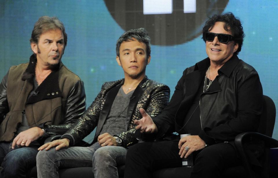 Three men sitting next to each other during a panel discussion