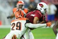 Arizona Cardinals wide receiver Larry Fitzgerald (11) makes a catch against Cincinnati Bengals strong safety Leon Hall (29) during the second half at University of Phoenix Stadium. The Cardinals won 34-31. Mandatory Credit: Joe Camporeale-USA TODAY Sports