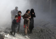 <p>Syrian civilians flee from reported regime air strikes in the rebel-held town of Jisreen, in the besieged Eastern Ghouta region on the outskirts of the capital Damascus, on Feb. 8, 2018. (Photo: Abdulmonam Eassa/AFP/Getty Images) </p>