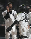 Chicago White Sox's Eloy Jiménez, left, and catcher Martín Maldonado (15) celebrate after a win over the Tampa Bay Rays in a baseball game Friday, April 26, 2024, in Chicago. (AP Photo/Charles Rex Arbogast)