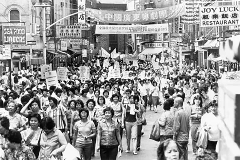 ILGWU members march through Chinatown to urge the remaining shops to sign the new contract, following the rally on July 15, 1982. (Courtesy of The Kheel Center ILGWU Collection, Cornell University)