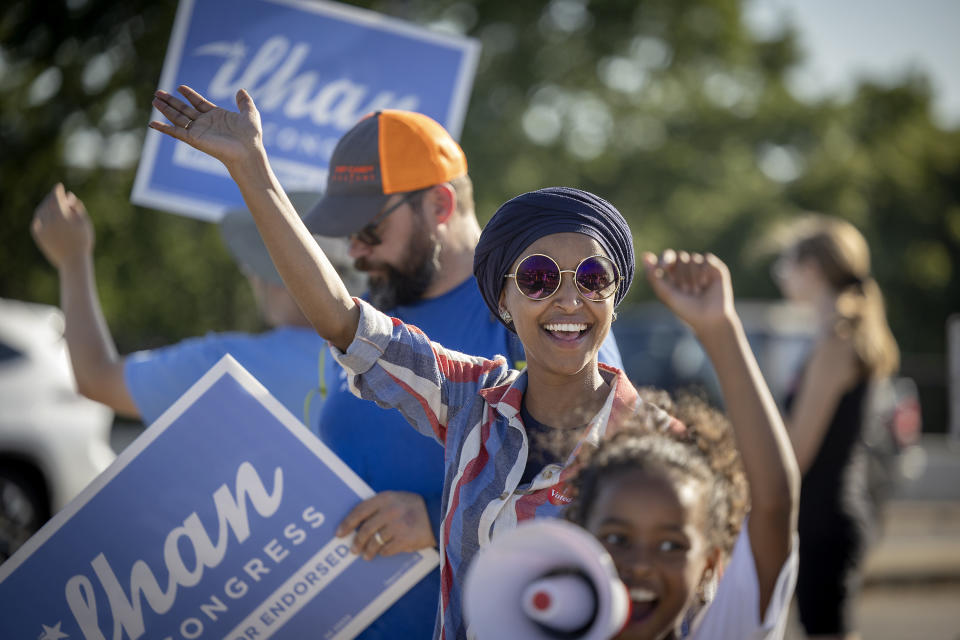 U.S. Rep. Ilhan Omar waves to passersby for support during a voter engagement event on the corner of Broadway and Central Avenues in Minneapolis, on Tuesday, Aug. 9, 2022. Omar faces a primary challenge from former city council member Don Samuels. (Elizabeth Flores/Star Tribune via AP)