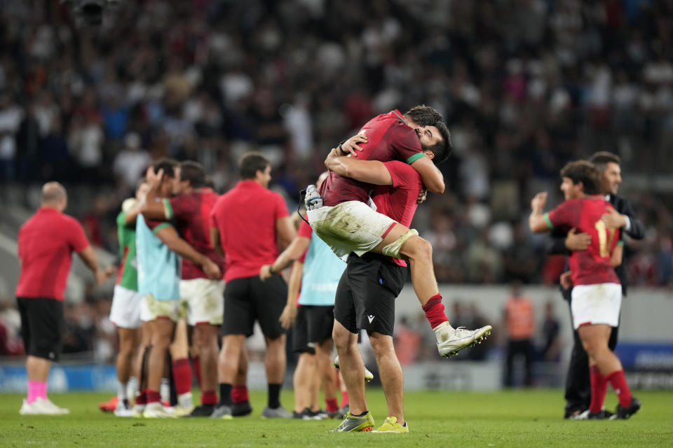 Portugal's players celebrate after the end of the Rugby World Cup Pool C match between Fiji and Portugal, at the Stadium de Toulouse in Toulouse, France, Sunday, Oct. 8, 2023. (AP Photo/Pavel Golovkin)
