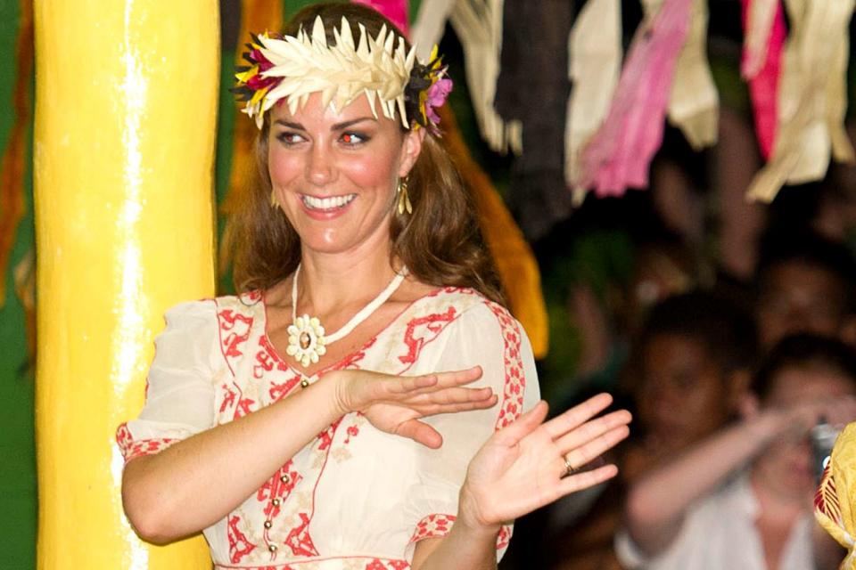 <p>Samir Hussein/WireImage</p> Kate Middleton dancing during a Vaiku Falekaupule Ceremony in Funafuti, Tuvalu in 2012.