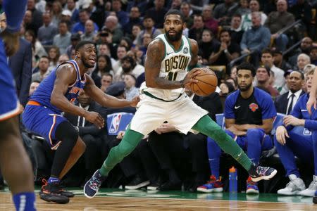 Dec 6, 2018; Boston, MA, USA; Boston Celtics guard Kyrie Irving (11) steps away from New York Knicks point guard Emmanuel Mudiay (1) during the second half at TD Garden. Greg M. Cooper-USA TODAY Sports