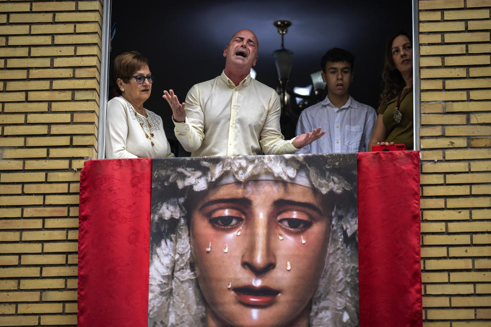 Worshipper Jose Maria Segura sings a "saeta" as the Virgin Mary is carried out of the church during the procession of "El Cerro" brotherhood in Seville, Spain, Tuesday, April 4, 2023. Hundreds of processions take place throughout Spain during the Easter Holy Week. (AP Photo/Emilio Morenatti)