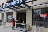 In this May 6, 2020 photo, a sign that reads "Hiring Today!" is posted in the window of a Domino's Pizza store open for delivery or pick-up only in downtown Seattle. The U.S. unemployment rate hit 14.7% in April, the highest rate since the Great Depression, as 20.5 million jobs vanished in the worst monthly loss on record. The figures are stark evidence of the damage the coronavirus has done to a now-shattered economy. (AP Photo/Ted S. Warren)