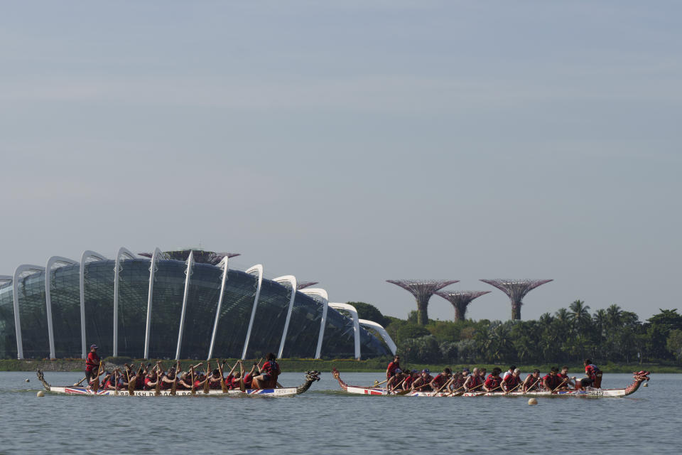 Britain's Prince William, on the boat at right, participates in a dragon boat event in Singapore, Monday, Nov. 6, 2023. (AP Photo/Vincent Thian)