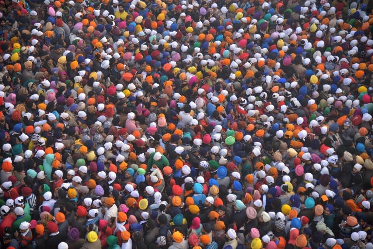 <p>Indian Sikh devotees pay respects on the first day of the year at the Golden Temple in Amritsar on January 1, 2016. </p>