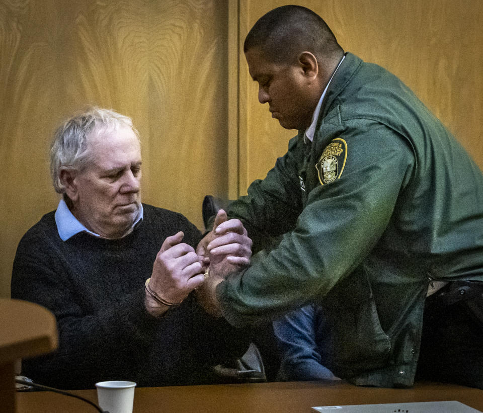 Robert Koehler, who authorities call the "Pillowcase Rapist," is handcuffed by a Miami-Dade Corrections and Rehabilitation Department officer after he was found guilt by a jury in his trial, Wednesday, Jan. 25, 2023, in Miami. (Jose A. Iglesias/Miami Herald via AP, Pool)