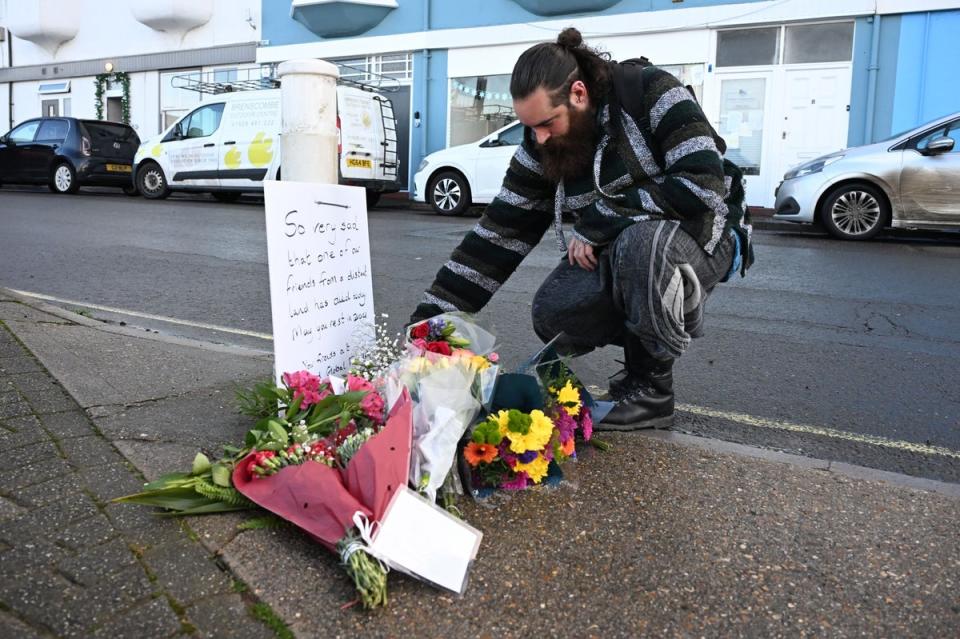 Residents lay flowers in memory of the asylum seeker who died on the vessel (Getty Images)