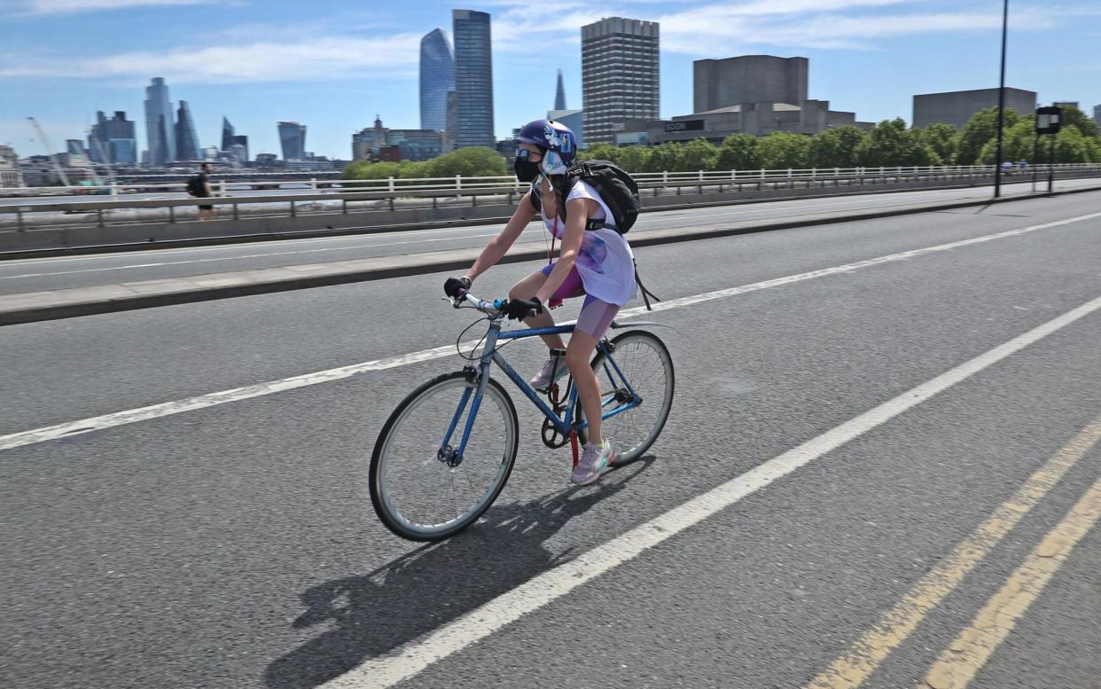 A cyclist on Waterloo Bridge in London, which may be restricted to people walking, cycling and buses only, with pavements widened so people can safely travel between busy railway stations and their workplaces as coronavirus restriction slowly begin to ease - PA