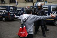 <p>A person confronts police trying to control the area as people head to the ballot box. (Getty) </p>