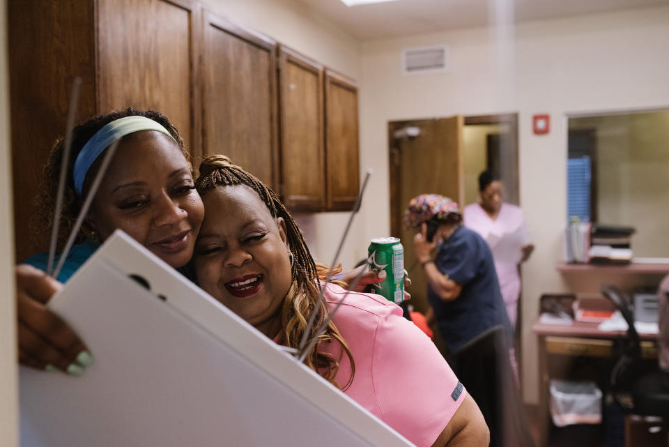 Medical assistant Ramona Wallace, left, embraces Gail Latham on July 11.<span class="copyright">Lucy Garrett for TIME</span>