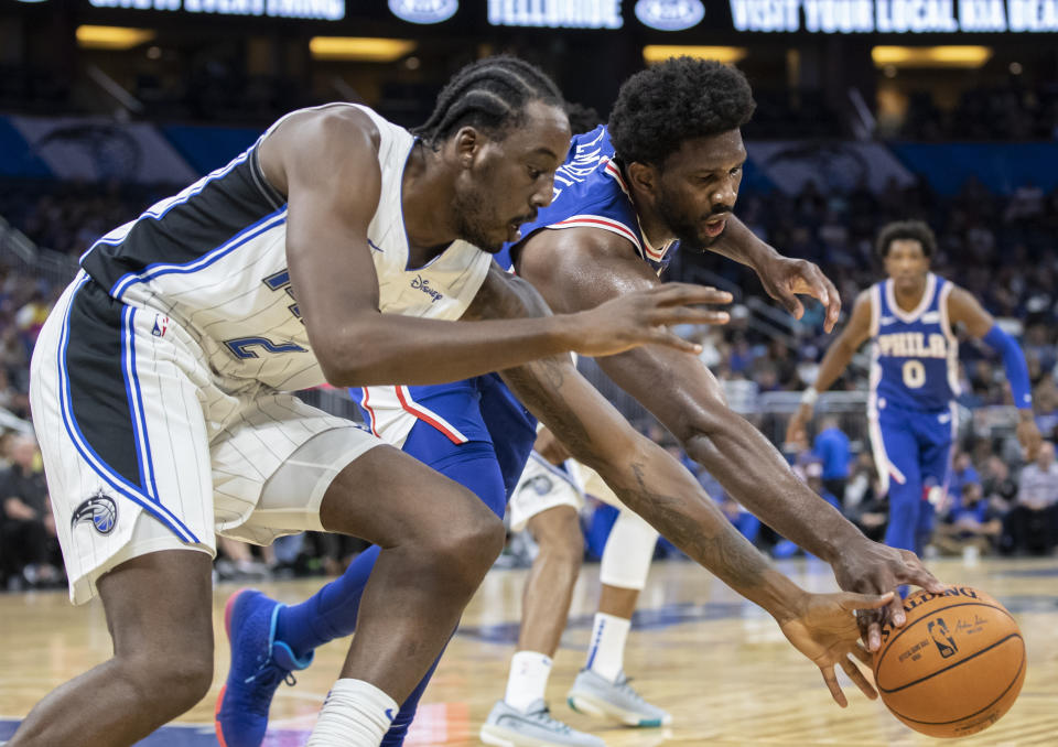 Orlando Magic forward (2) Al-Farouq Aminu and Philadelphia 76ers center Joel Embiid fight for the ball during the first half of a preseason NBA basketball game in Orlando, Fla., Sunday, Oct. 13, 2019. (AP Photo/Willie J. Allen Jr.)