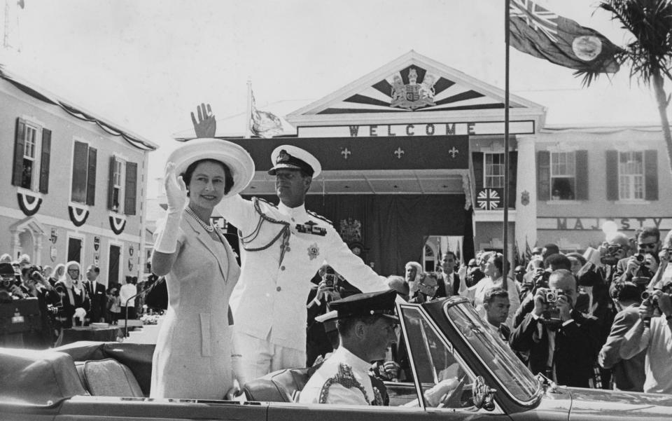  Queen Elizabeth II and Prince Philip wave to crowds from their car, on their arrival in Nassau, Bahamas, - Bride Lane Library/Popperfoto