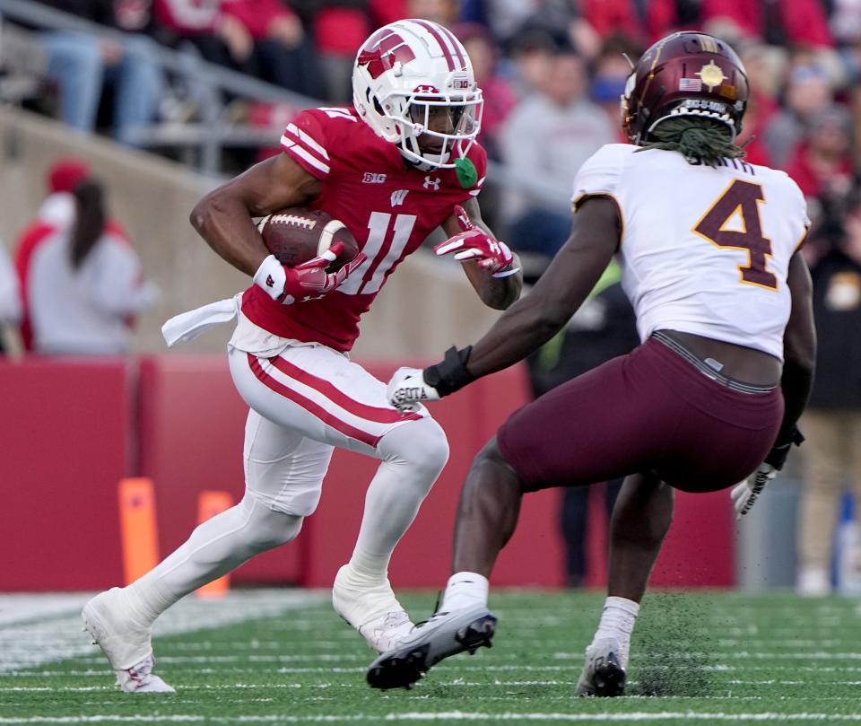 Wisconsin wide receiver Skyler Bell makes a reception for a first down while being covered by Minnesota defensive back Terell Smith during the first quarter Saturday.