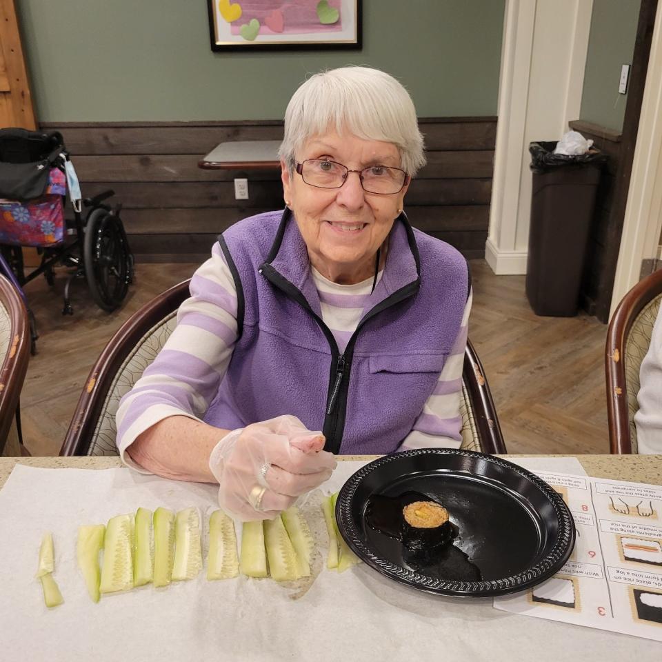 Resident Judy Sanphy learns how to roll her own sushi as part of Grab Your Passport! days at Cornerstone at Hampton.
