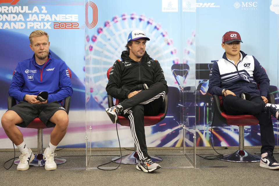 Haas driver Kevin Magnussen, left, of Denmark and Alpine driver Fernando Alonso, center, of Spain amd AlphaTauri driver Yuki Tsunoda of Japan attend a news conference, ahead of the Japanese Formula One Grand Prix at the Suzuka Circuit in Suzuka, central Japan, Thursday, Oct. 6, 2022. (AP Photo/Eugene Hoshiko)