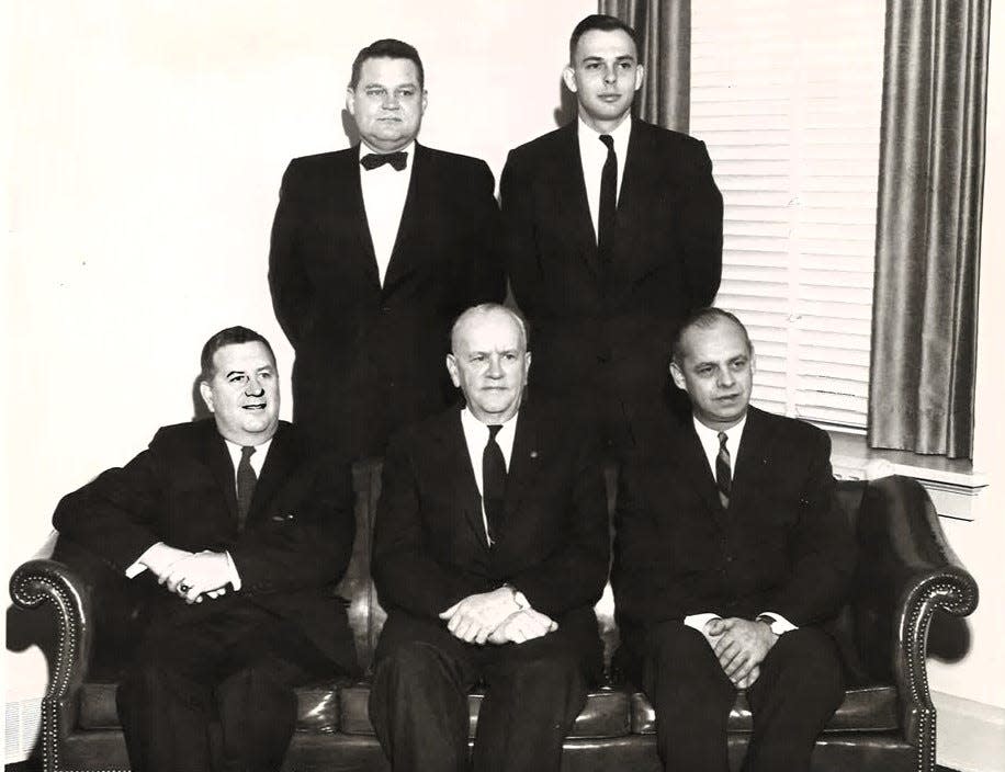 Milan E. Frase, Eugene R. Weir, standing, and Lawrence Burns Jr., Warner M. Pomerene and Charles S. Milligan , seated, are show in this Nov. 9, 1959 photograph. They were celebrating their law firm's 100th anniversary. Today the firm is known as Pomerene, Burns and Skelton and is the longest continual law firm in Ohio.