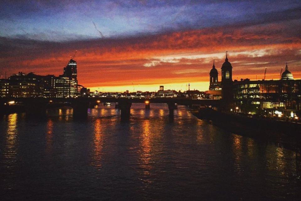 'Beautiful': One Londoner shared this image of the sun setting over the Thames on Wednesday night (@EllieJeanUlrich)