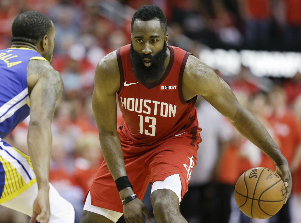 Houston Rockets guard James Harden (13) dribbles as Golden State Warriors guard Andre Iguodala defends during the second half of Game 3 of a second-round NBA basketball playoff series, Saturday, May 4, 2019, in Houston. (AP Photo/Eric Christian Smith)