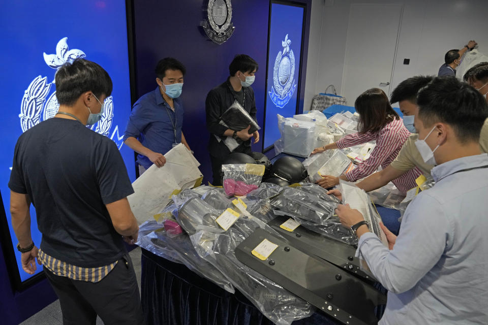 Police officers display the confiscated evidence during a news conference as nine people were arrested over the alleged plot to plant bombs around Hong Kong, at the police headquarters in Hong Kong, Tuesday, July 6, 2021. (AP Photo/Kin Cheung)