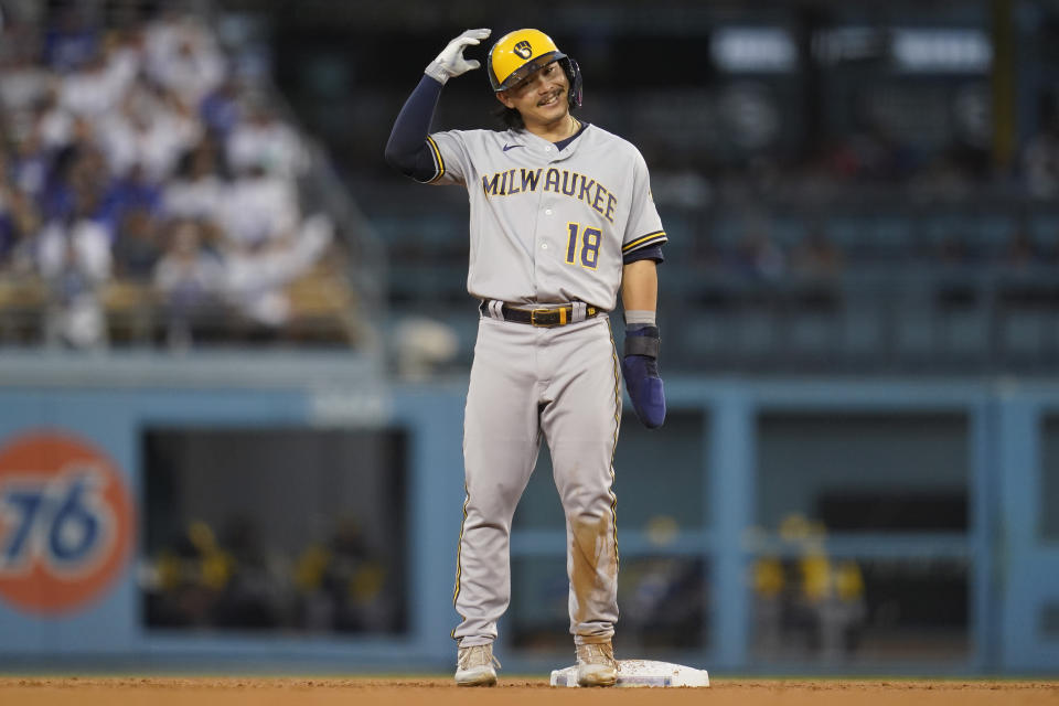 Milwaukee Brewers designated hitter Keston Hiura (18) reacts after reaching second on a wild pitch during the second inning of a baseball game against the Los Angeles Dodgers in Los Angeles, Tuesday, Aug. 23, 2022. (AP Photo/Ashley Landis)