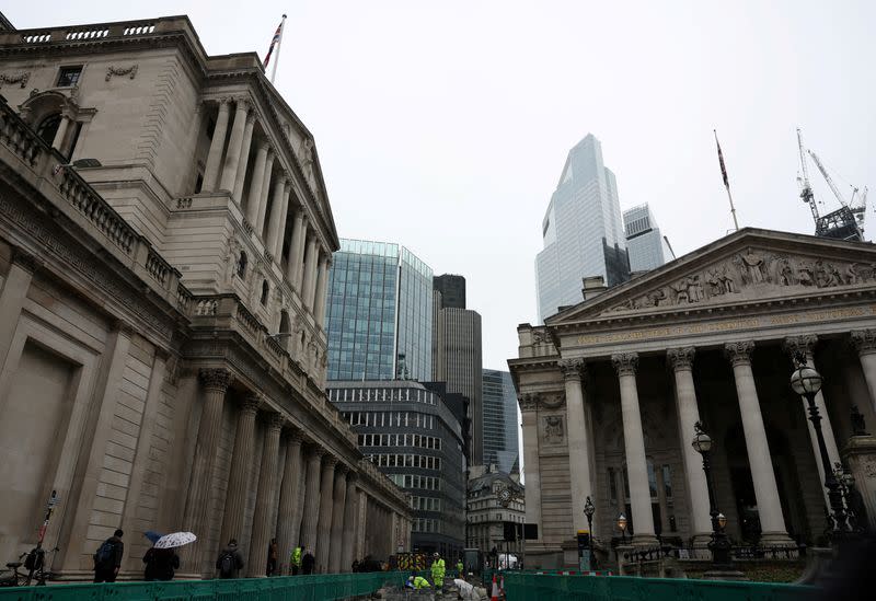 FILE PHOTO: Road construction workers carry out work outside the Bank of England in the City of London financial district