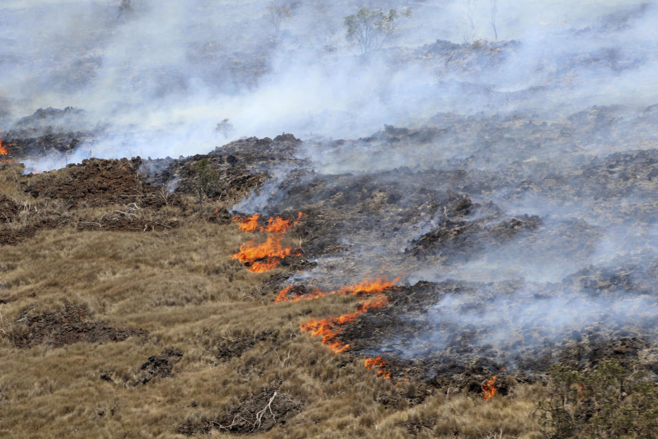 This photo provided by the Hawaii Department of Land and Natural Resources shows a large wildfire in a rural area of Hawaii's Big Island that is not threatening any homes, but high winds and extremely dry conditions are making it difficult for crews to contain the blaze. (Hawaii Department of Land and Natural Resources via AP)