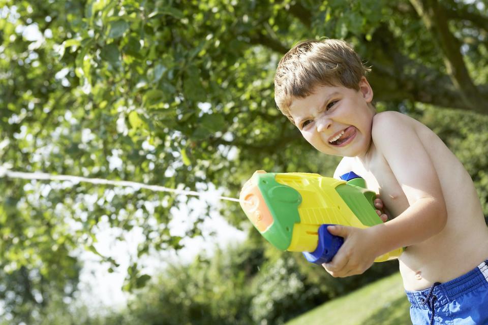 Certain kinds of games and play can influence how kids try to solve real world problems. <a href="https://www.gettyimages.com/detail/photo/boy-in-park-shooting-pump-action-water-pistol-royalty-free-image/103579216" rel="nofollow noopener" target="_blank" data-ylk="slk:moodboard/Image Source via Getty Images;elm:context_link;itc:0;sec:content-canvas" class="link ">moodboard/Image Source via Getty Images</a>