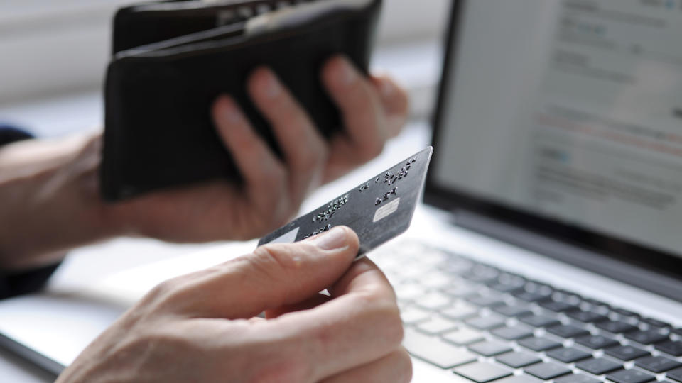 Hand holding a credit card ready to pay for an online purchase