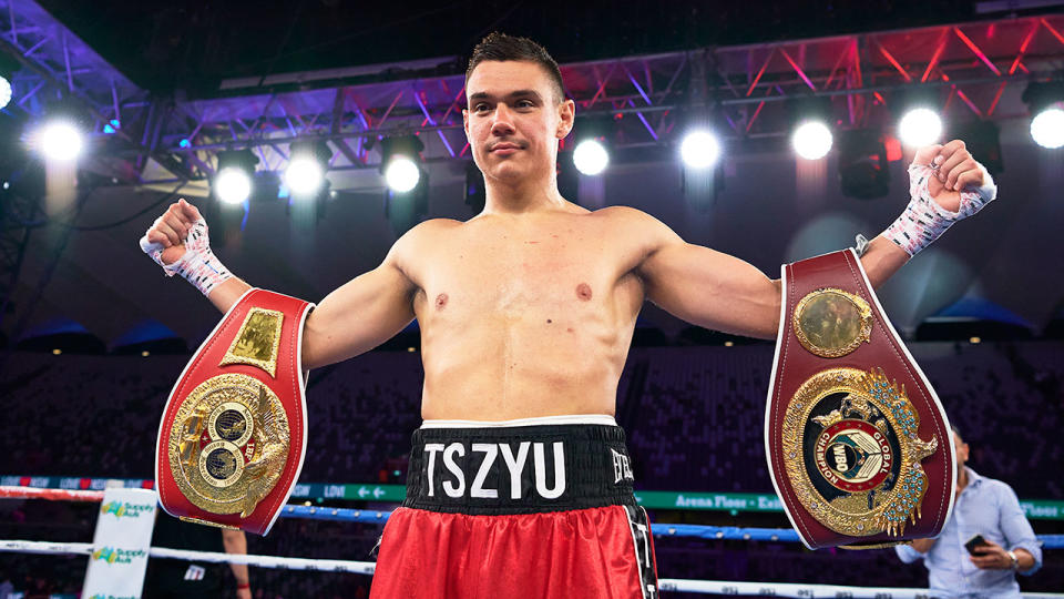 Seen here, Tim Tszyu holds his belts up after a big win on Wednesday night.