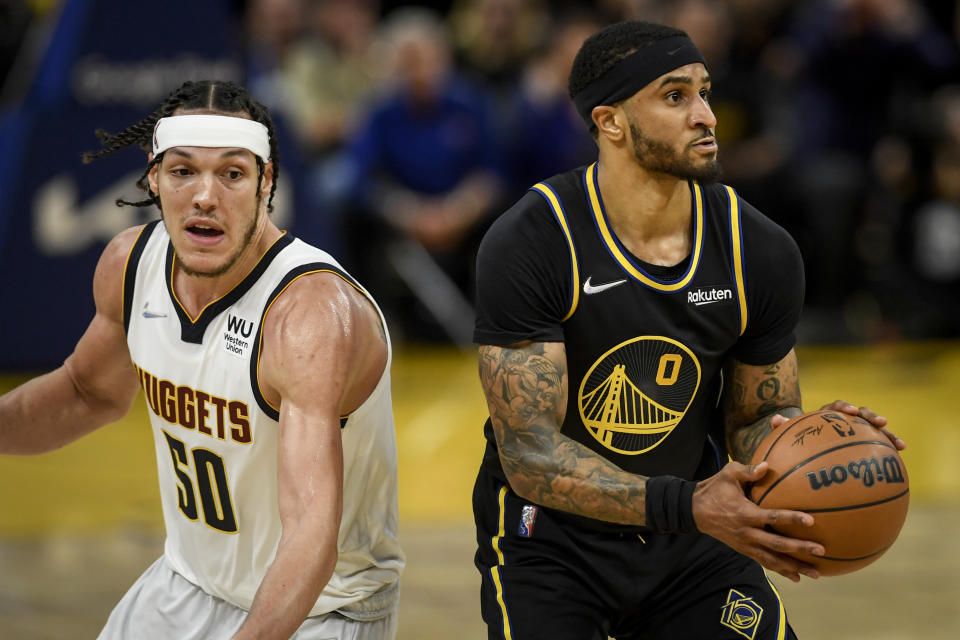 SAN FRANCISCO , CA - APRIL 27: Gary Payton II (0) of the Golden State Warriors spots up for a dagger three as Aaron Gordon (50) of the Denver Nuggets defends during the fourth quarter of Golden State