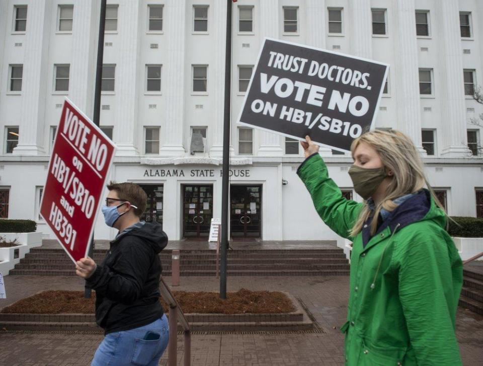 Protestors in support of transgender rights march around the Alabama State House in Montgomery, Alabama, on Tuesday, March 2, 2021.  / Credit: Jake Crandall//The Montgomery Advertiser via AP